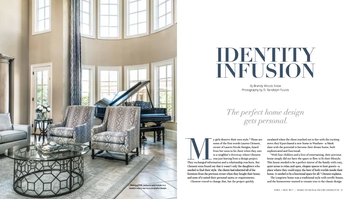 A two-page magazine spread showing a very tall, sunlit foyer features a black grand piano beneath arched windows, flanked by two patterned chairs and a glass coffee table.