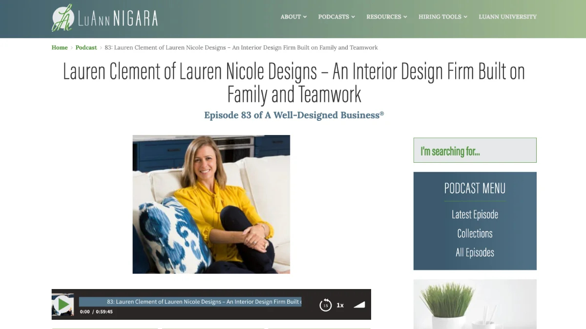 A screenshot of a website podcast showing Lauren Clement, smiling, sits comfortably on a white sofa wearing a bright yellow blouse, with decorative blue and white pillows and blue cabinetry in the background.